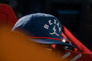 Close-up of the Bexar Goods logo patch on the Blue Bexar Cap