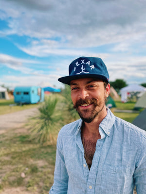 Model wearing the Blue Bexar Cap outdoors, demonstrating the perfect fit and style