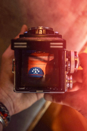 Close-up of the Bexar Goods logo patch on the Blue Bexar Cap